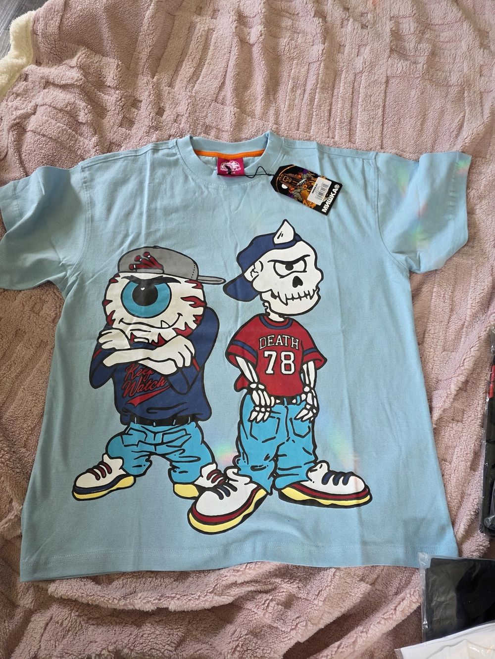 Mishka NYC graphic T-shirt features their signature "Keep Watch" giant eyeball c